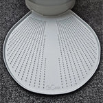 Eine weiße, strukturierte CatGenie GenieMat sitzt vor einem Katzenklo auf einem dunklen Teppichboden. Sie wurde entwickelt, um streunendes CatGenie Granulat aufzufangen und Ihren Raum sauber zu halten.